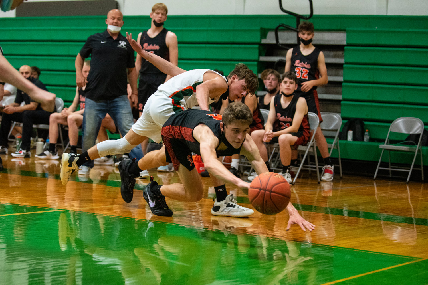 Rainier's Ian Sprouffske dives for a loose ball with MWP's Layten Collette behind him.