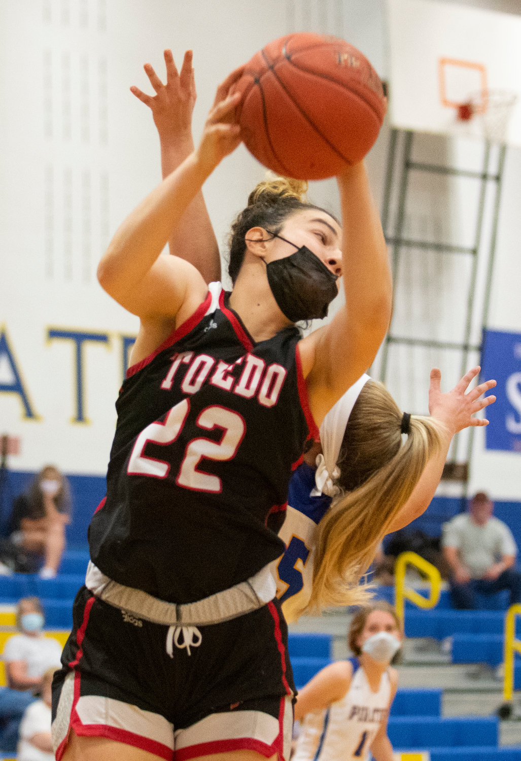 Toledo sophomore Abbie Marcil (22) pulls down an offensive rebound against Adna on Thursday.