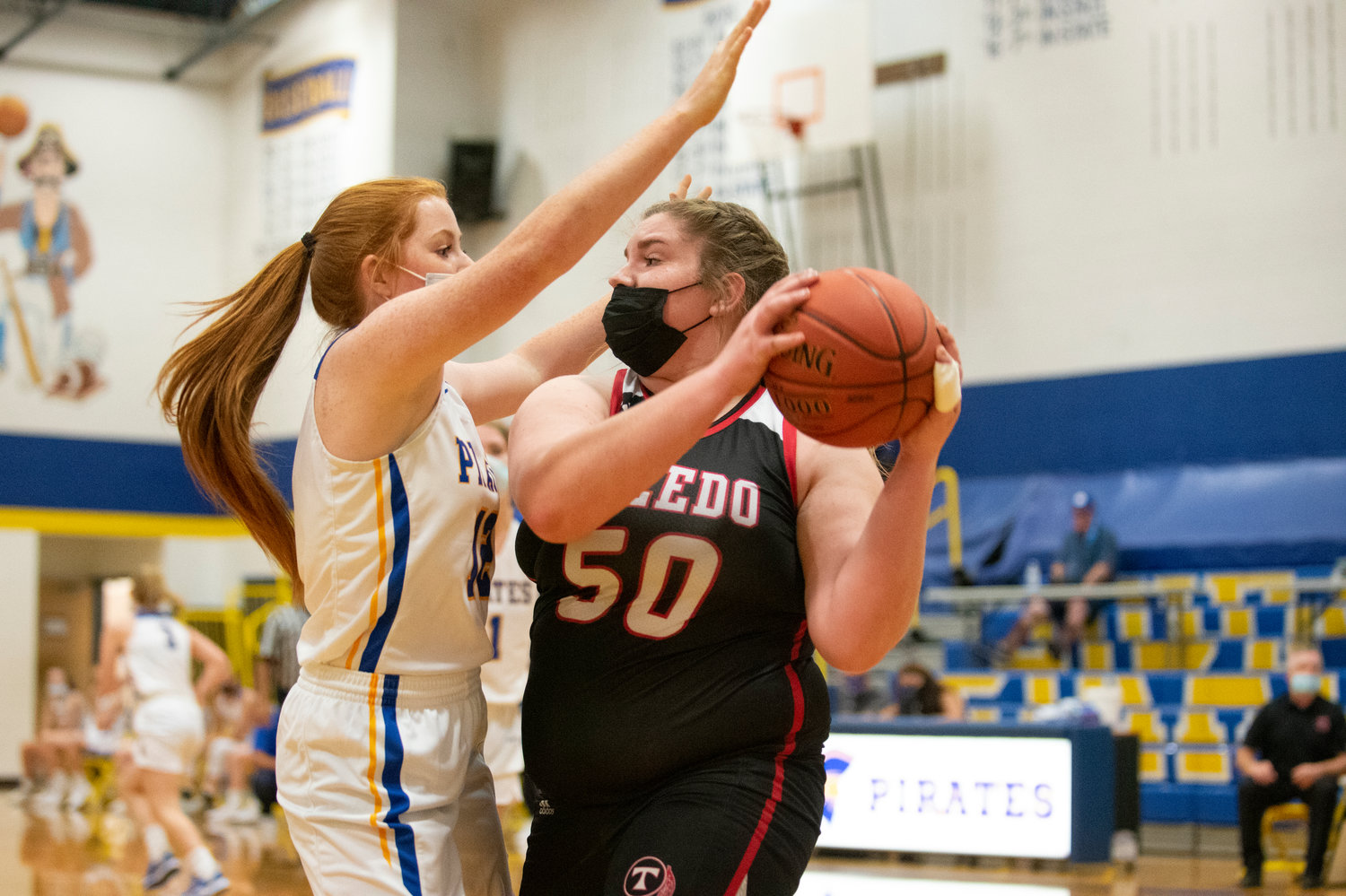 Toledo's Taylor Langhaim (50) looks for an open pass against Adna's Natalie Loose (12) after hauling in a defensive rebound.