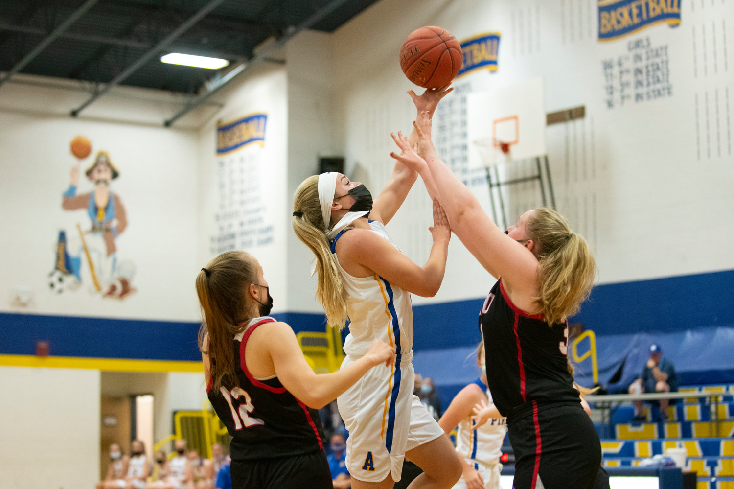 Adna junior Kaylin Todd goes up for a layin against Toledo's Gracie Madill (12) and Stacie Spahr at home on Thursday.