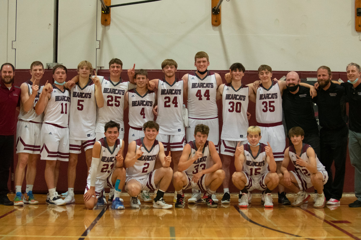 W.F. West boys basketball team holds up the No. 1 sign after defeating Black Hills for the 2A Evergreen Conference title on Friday.
