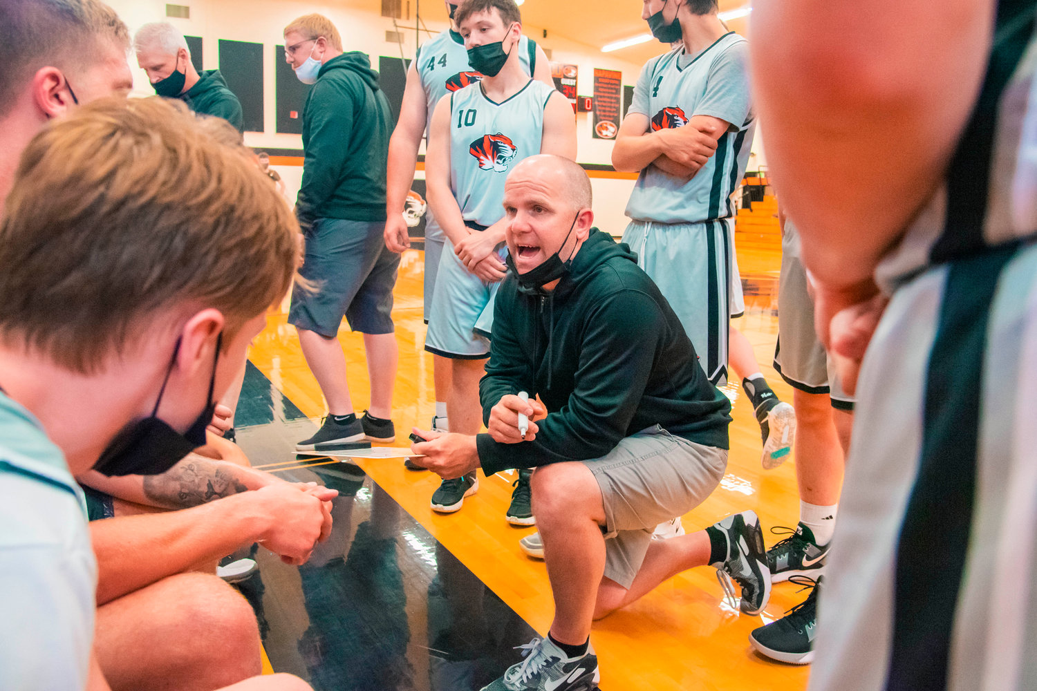 Head Coach Rex Stanley talks to players during a game in Napavine on Monday.