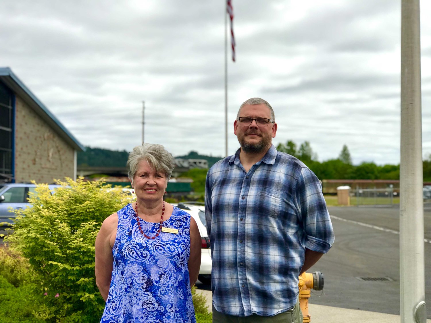 Anne Stedham, president of the Friendly Neighbors Garden Club, and Chip Duncan, the Veterans Memorial Museum executive director, pose for a photo outside the Veterans Memorial Museum in Chehalis.