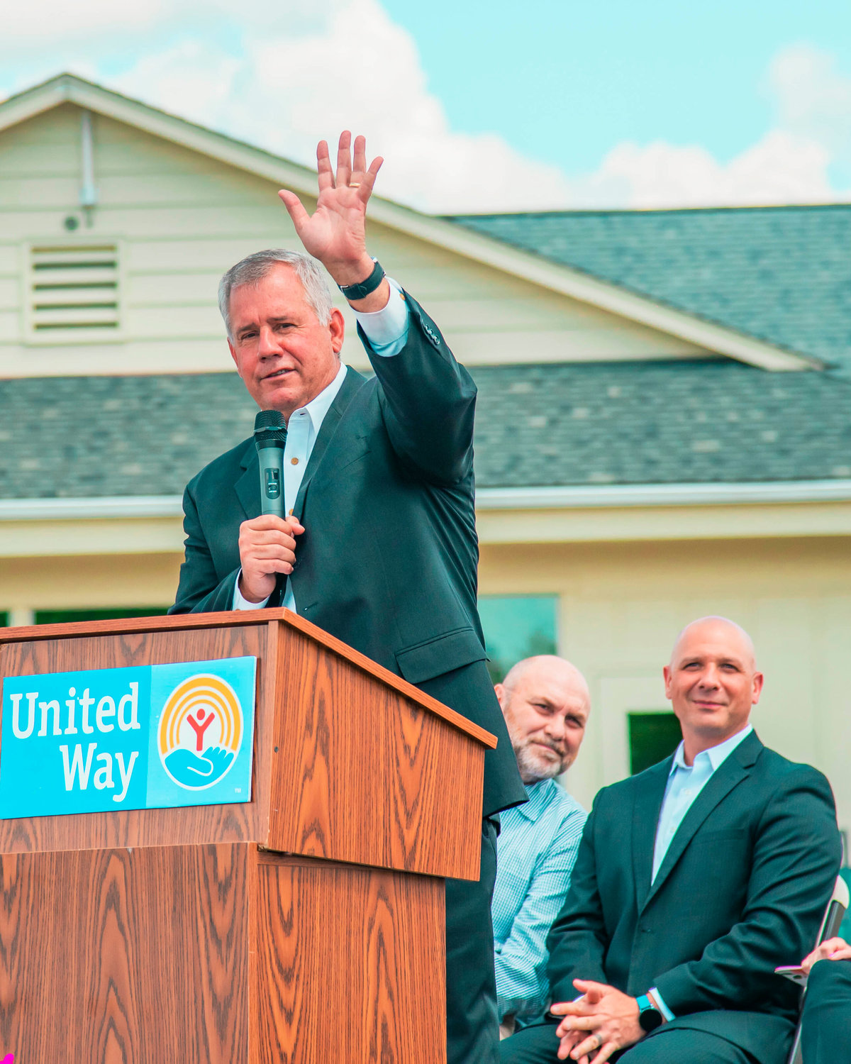 Director of the Lewis Economic Development Council Richard DeBolt raises his hand while addressing attendees of a groundbreaking event for the United Learning Center in Centralia on Tuesday.