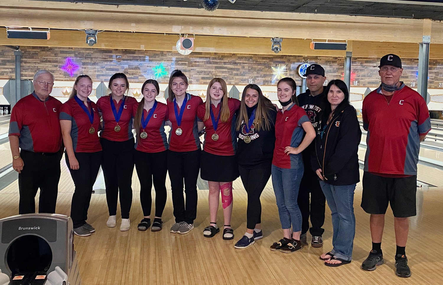 The W.F. West girls bowling team won their second-straight district championship Wednesday in Longview. From left, coach Bob Spahr, Cami Aldrich, Clara Bunker, Jessica Loflin, Brianna Powe, Piper Chalmers, Anahbelle Lopez, Audrey Toynbee, coach Don Bunker, coach Cassandra Chalmers and coach Rich Bunker