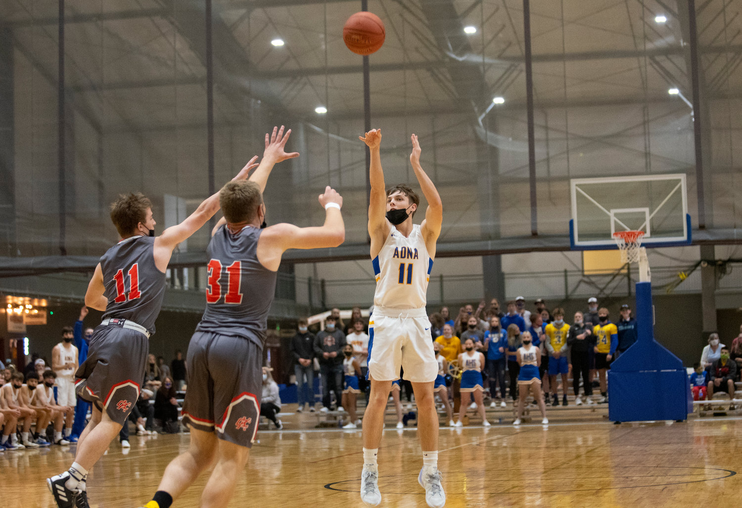 Adna junior Chase Collins (11) shoots  3-pointer against Kalama in the district semifinals on Wednesday.