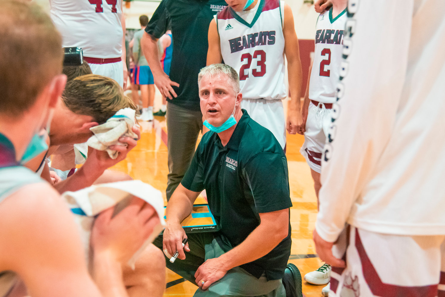 Head Coach Chris White talks to players during a game Wednesday night at W.F. West.
