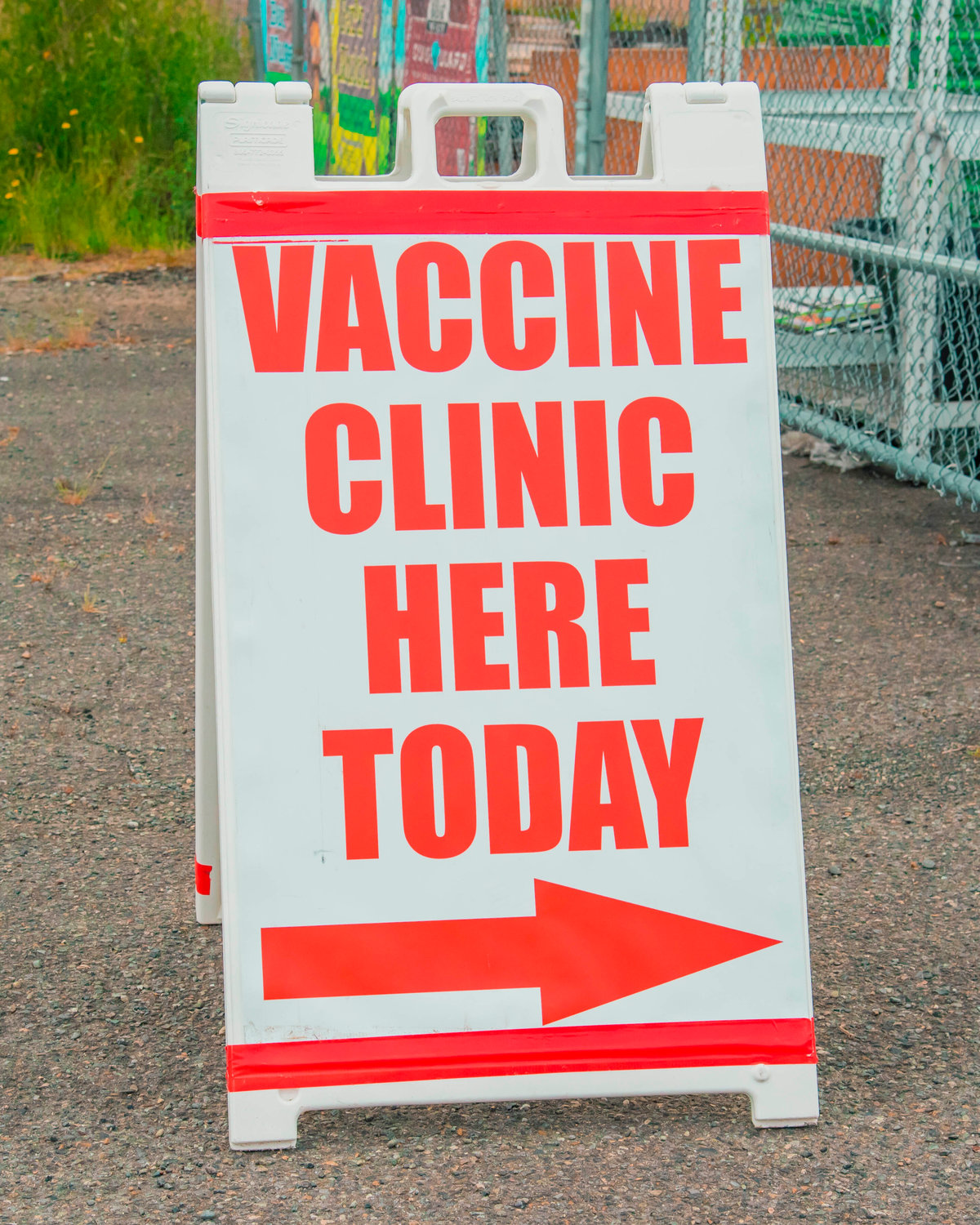 A sign points towards a vaccine clinic held at the Market Street Ace on Thursday in Chehalis.