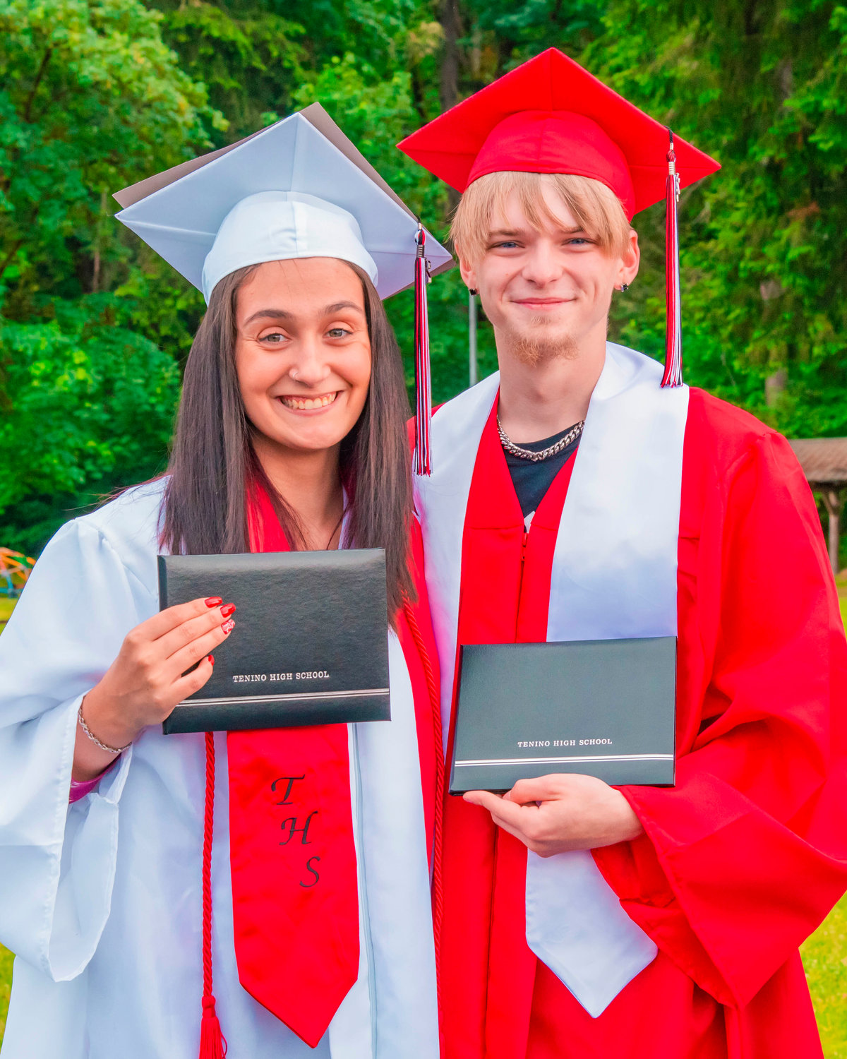 Shyanna Dunlap and Gage Burge smile and pose for photo at Tenino City Park following a parade for graduates on Friday.