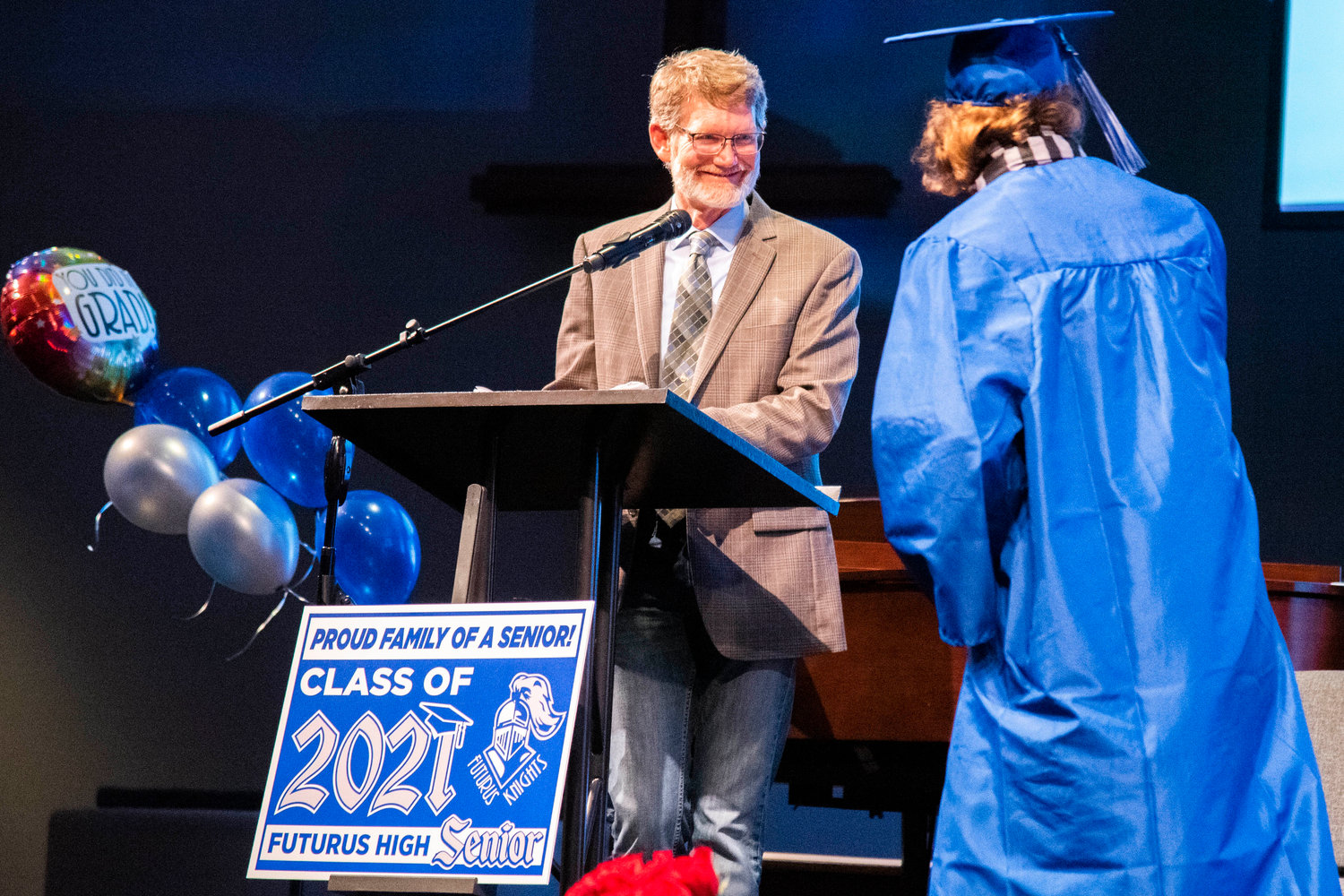 Steve Warren smiles as he announces the names of graduates during the Futurus High School graduation ceremony at the Centralia Community Church of God on Tuesday.