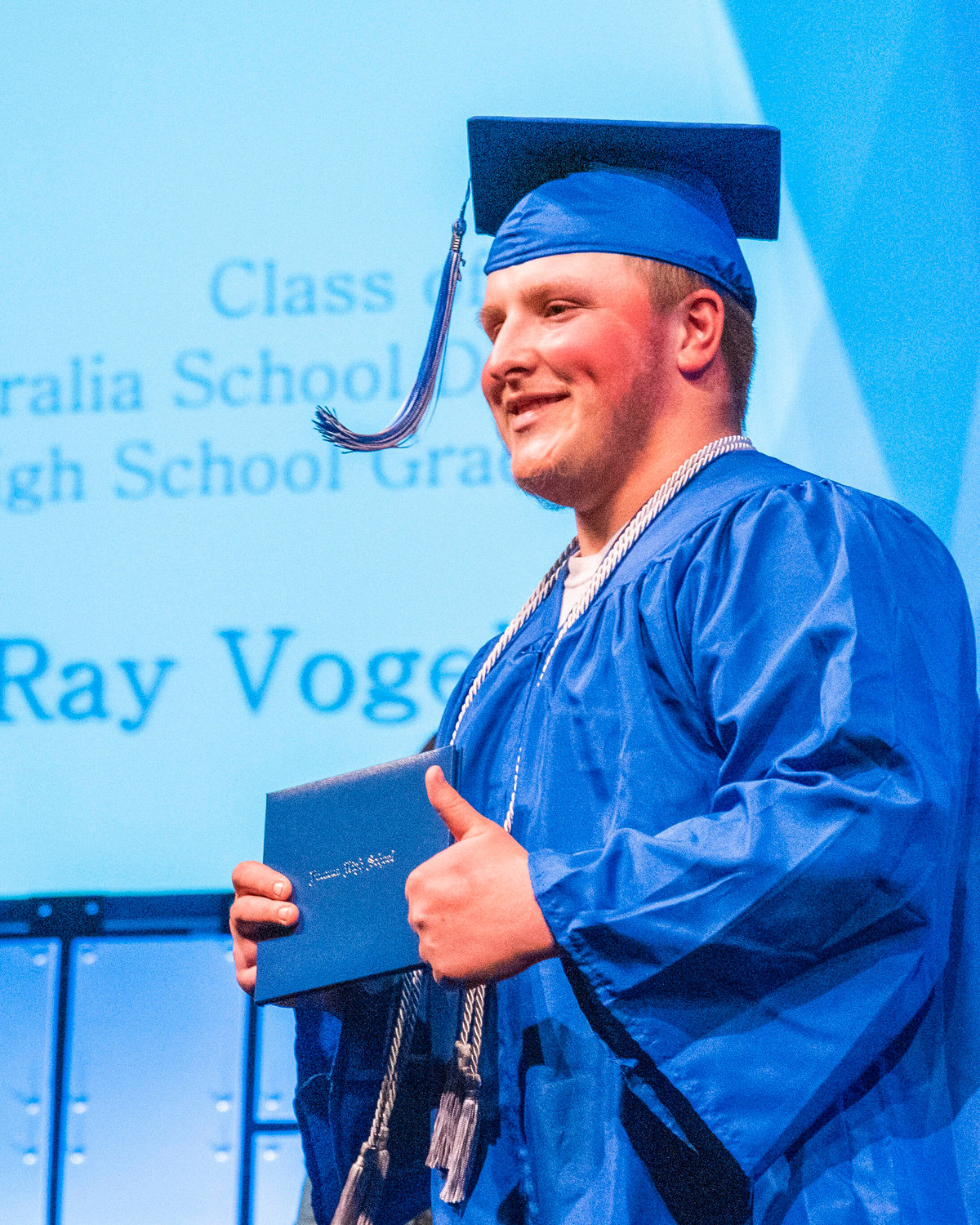 Sawyer Ray Vogel smiles and gives thumbs up while holding his diploma during the Futurus High School graduation ceremony at the Centralia Community Church of God on Tuesday.