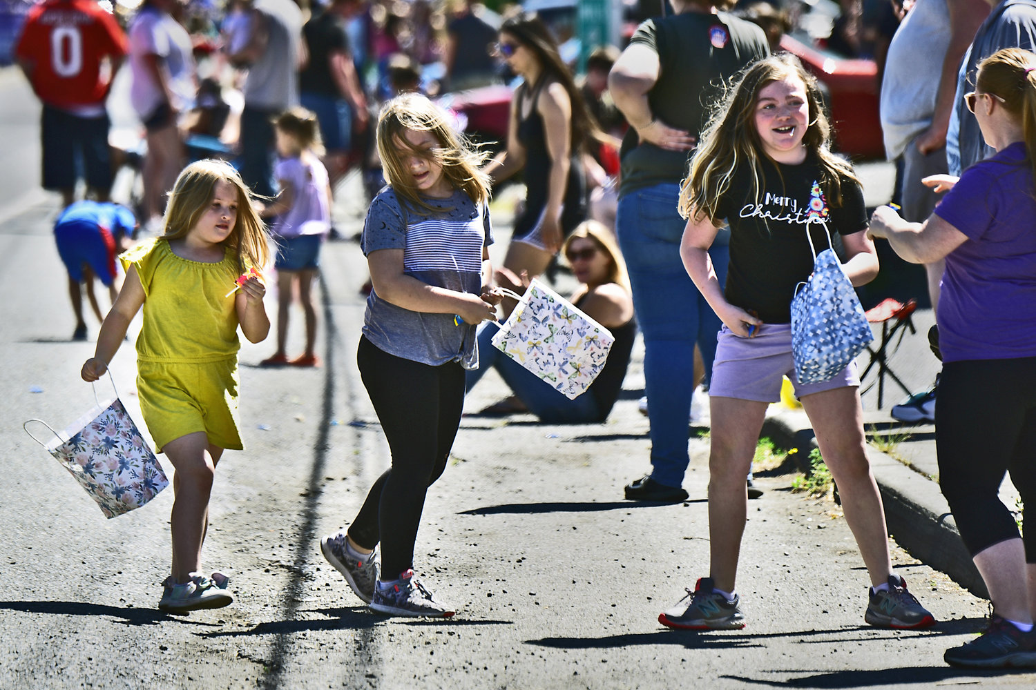 Kids scramble for candy thrown their way during the Swede Day parade on Saturday, June 19, in Rochester.
