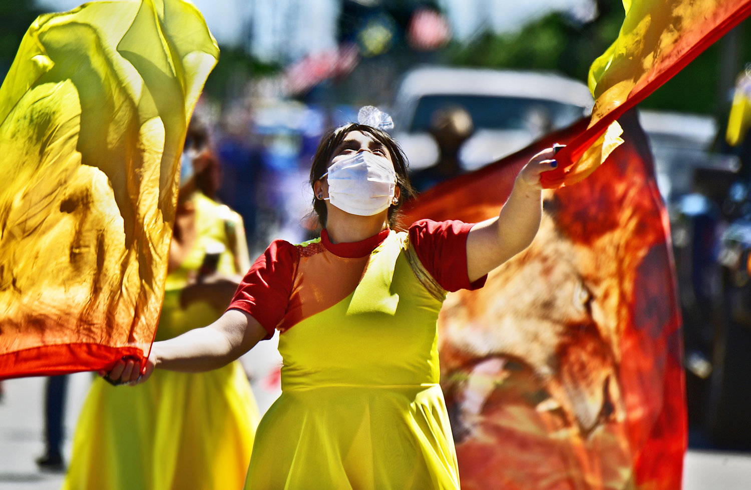 A member of the Iglesia Centro Familiar Cristiano Christian Church in Rochester dances and swirls tapestries during the Swede Day parade in downtown Rochester on Saturday, June 19.