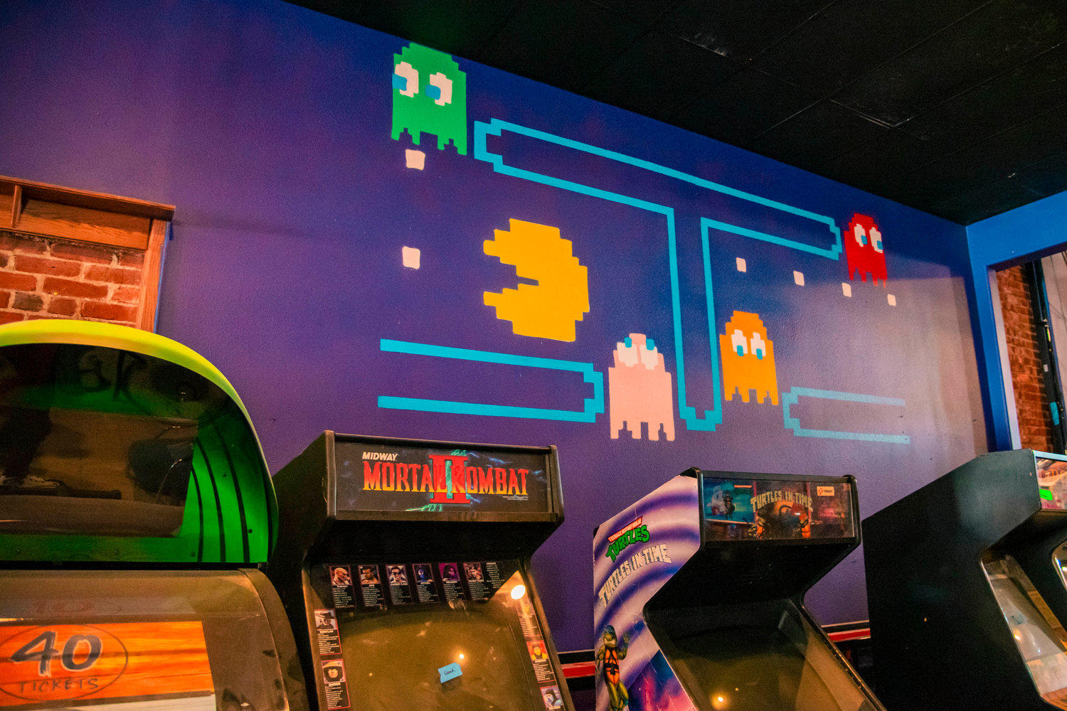 A Pac Man mural is displayed above arcade machines at Insert Coin in Centralia seen Thursday.