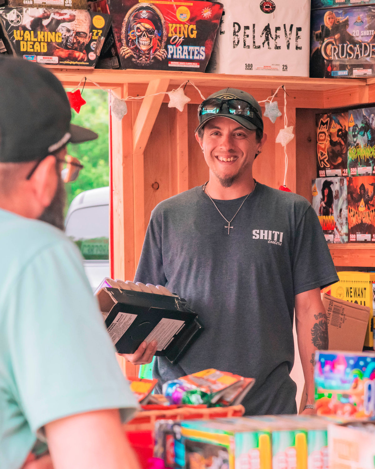 Joseph Wittwer smiles while talking to customers at his firework stand off Anderson Road SW on Thursday.