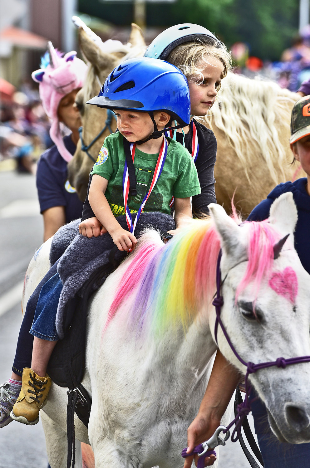 A couple of cute kids ride a “unicorn horse” during Oakville’s Independence Day parade on Saturday, July 3.
