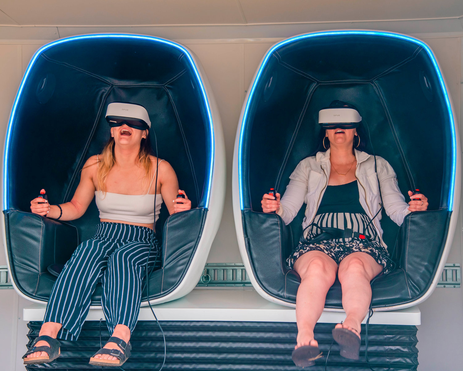 Gabby and Lynn Szigeti react while sitting in a 9-D virtual reality experience during the Mossyrock Freedom Festival in Klickitat Prairie Park on Saturday.