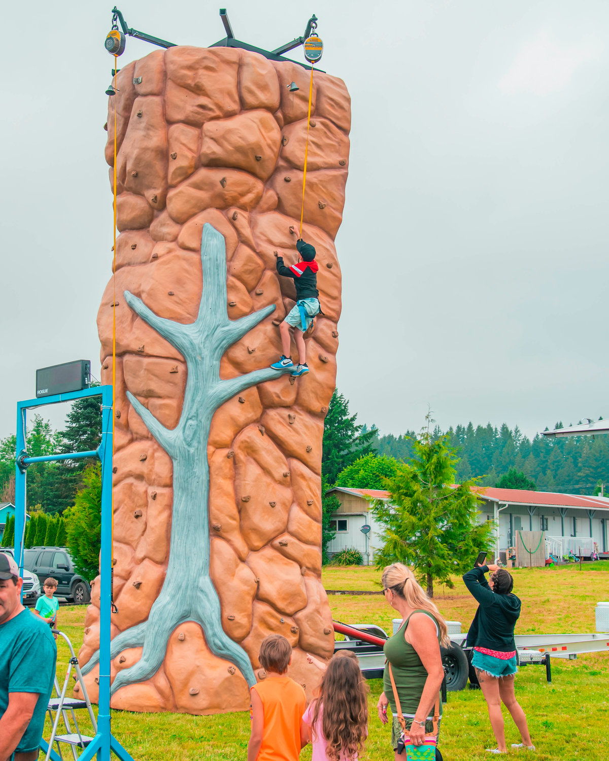 A rock wall is scaled during the Mossyrock Freedom Festival on Saturday in Klickitat Prairie Park.