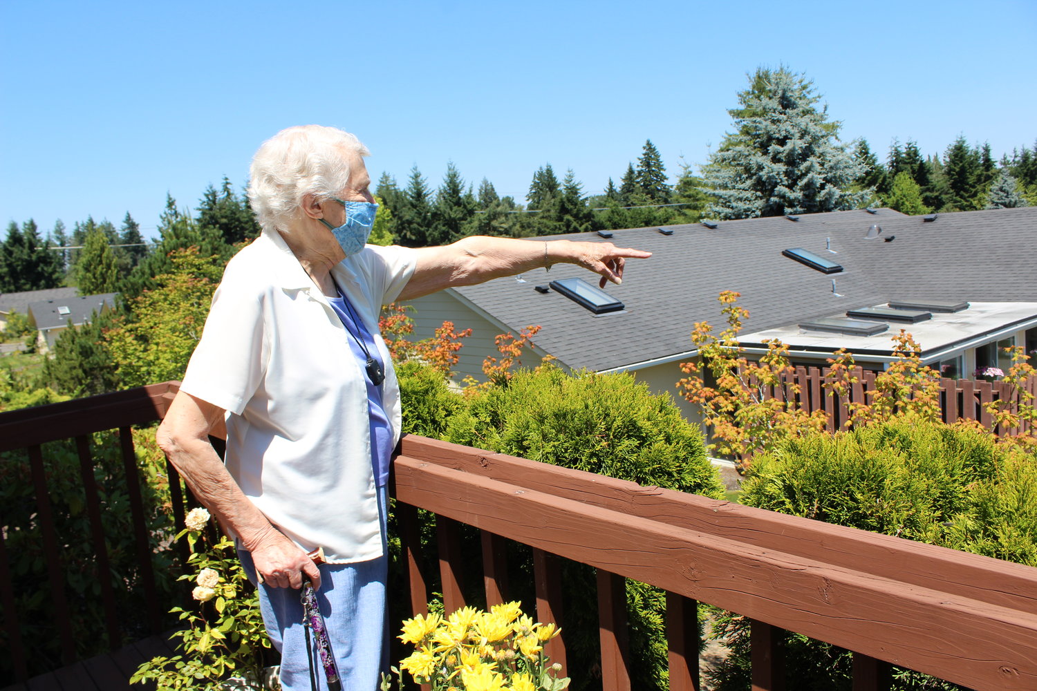 Audrey Kimball, a resident of Stillwaters since 2003, points to where you can usually see Mount Rainier from her balcony. Kimball, who calls herself Stillwaters' greatest fan, said the community is filled with active, interesting and interested people.