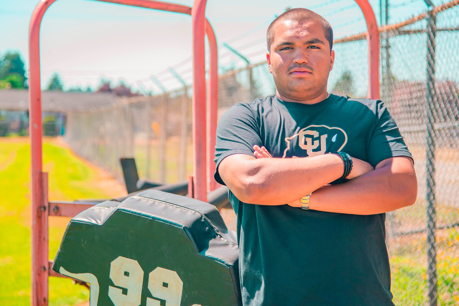 Paris Chavez poses for a photo next to football equipment in the Centralia High School practice field Monday afternoon behind Tiger Stadium.
