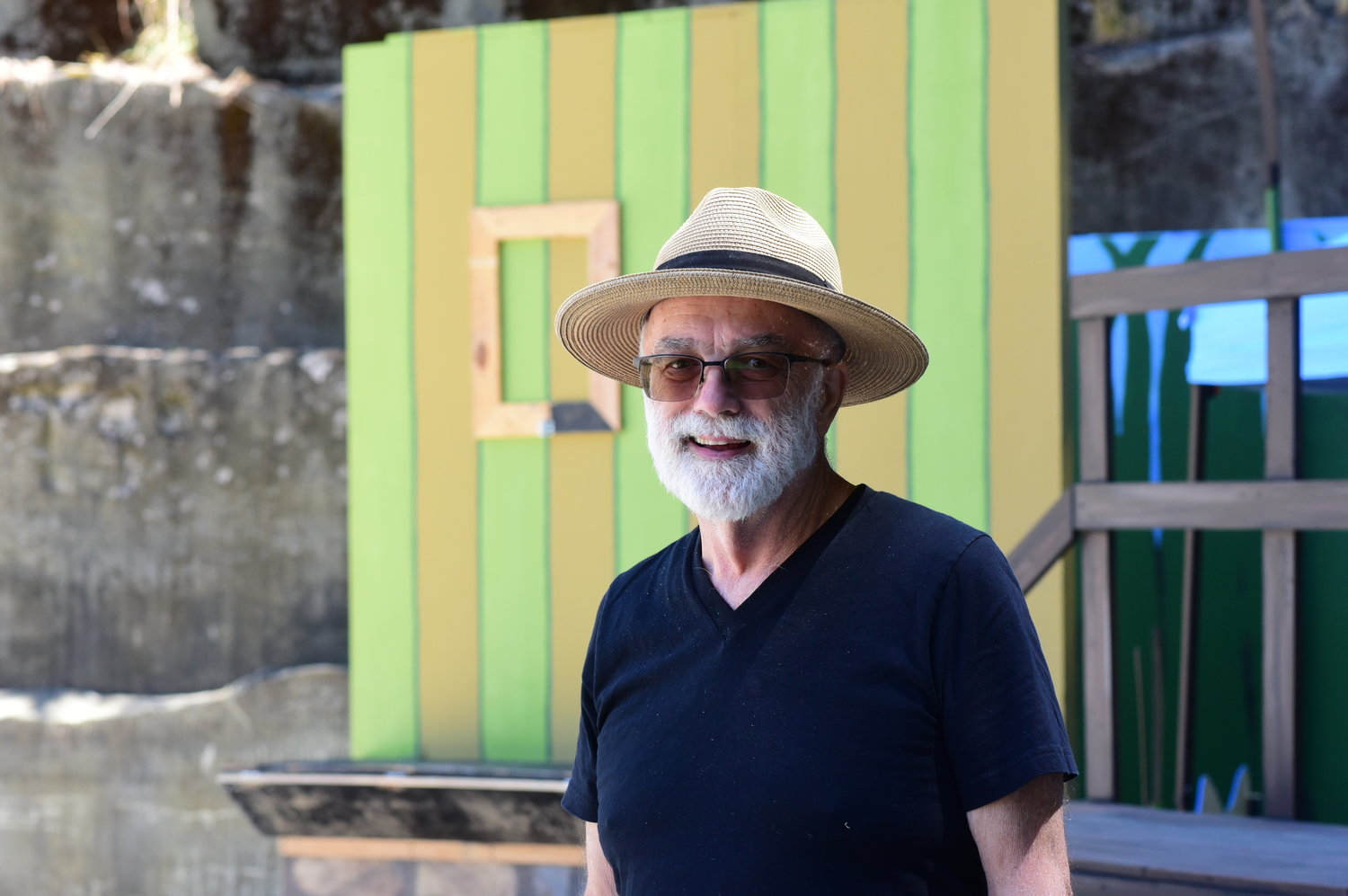 Bob McKenzieSullivan, managing director for the Tenino Young-at-Heart Theatre, stands in front of the set of "A Year With Frog and Toad" in the drained Tenino Quarry Pool.