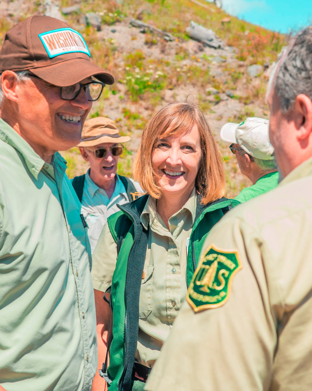 Gala Miller, Community Engagement Specialist with the U.S. Forest Service mingles with Gov. Jay Inslee and Bill Nye during a visit to the Johnston Ridge Observatory Thursday afternoon.