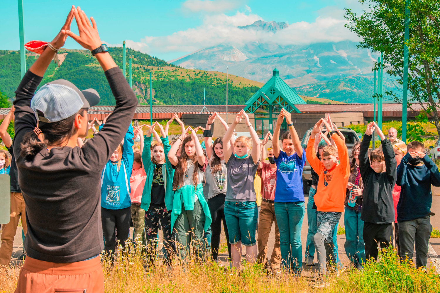 Students from the Springwater Environmental Sciences School in Oregon with the Mount St. Helens Insitute participate in a physical activity to learn about the eruption Thursday afternoon outside the Mount St. Helens Science and Learning Center in Toutle.