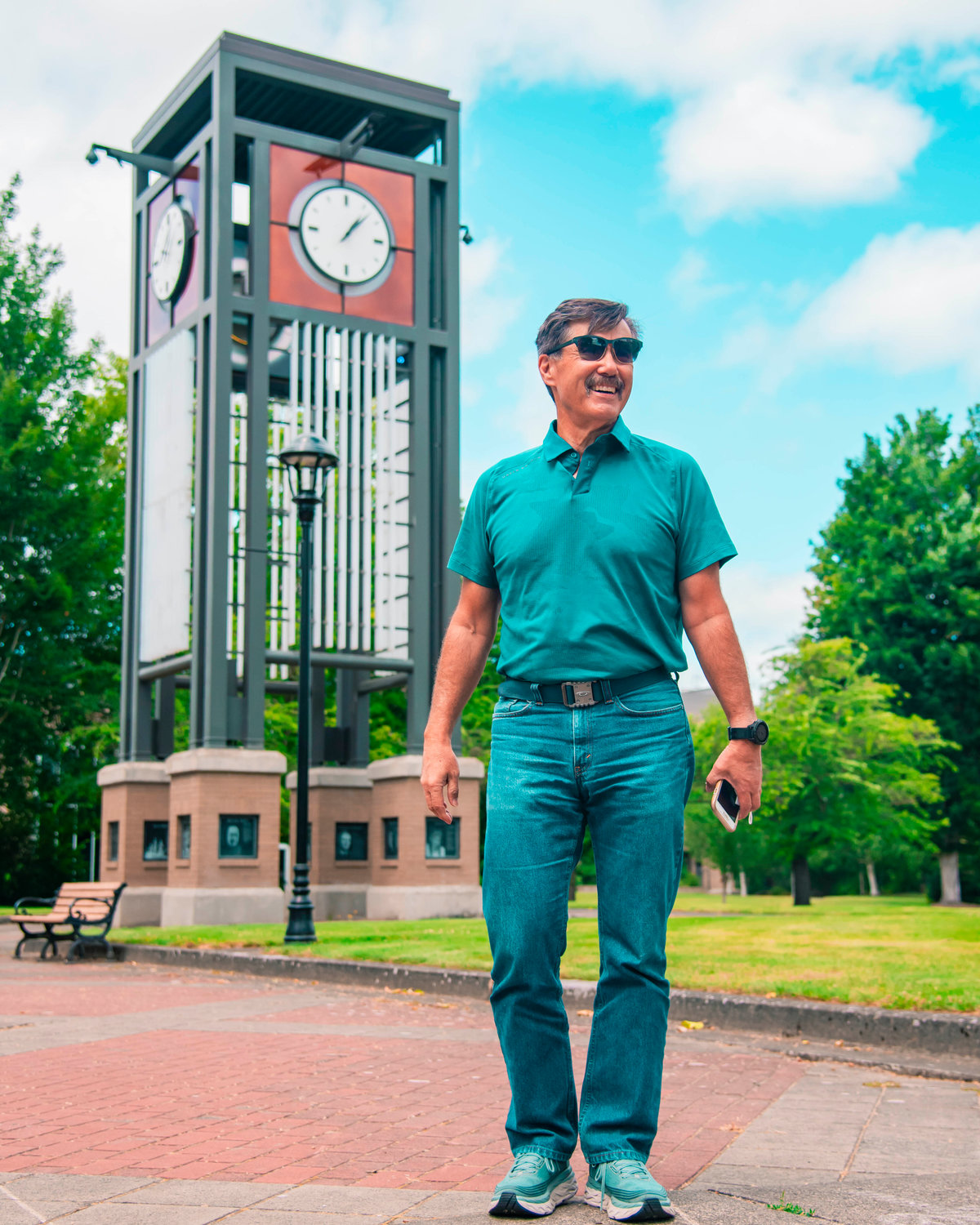 Steve Ward smiles while standing in front of the Centralia College clock tower Wednesday afternoon while talking about the many  changes made to the structure over the years.