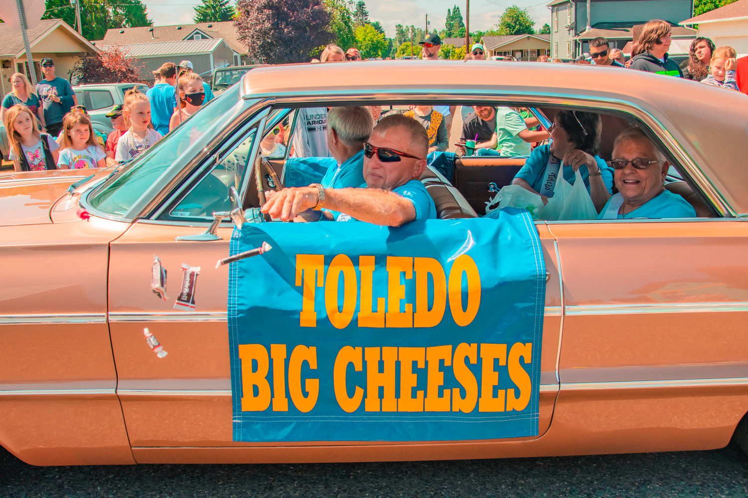 Candy is thrown to crowds as the Big Cheeses drive by during a parade in downtown Toledo on Saturday.