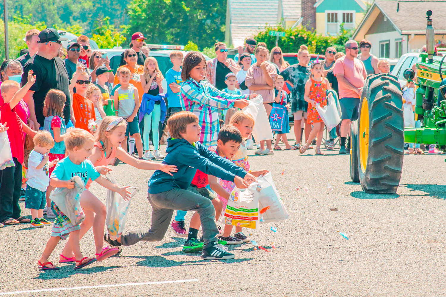 Kids attempt to catch candy in bags during the Toledo Cheese Days parade on Saturday.