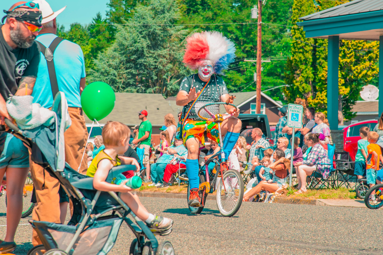 An Astoria Clown waves from a bike during the Toledo Cheese Days parade Saturday in downtown Toledo.