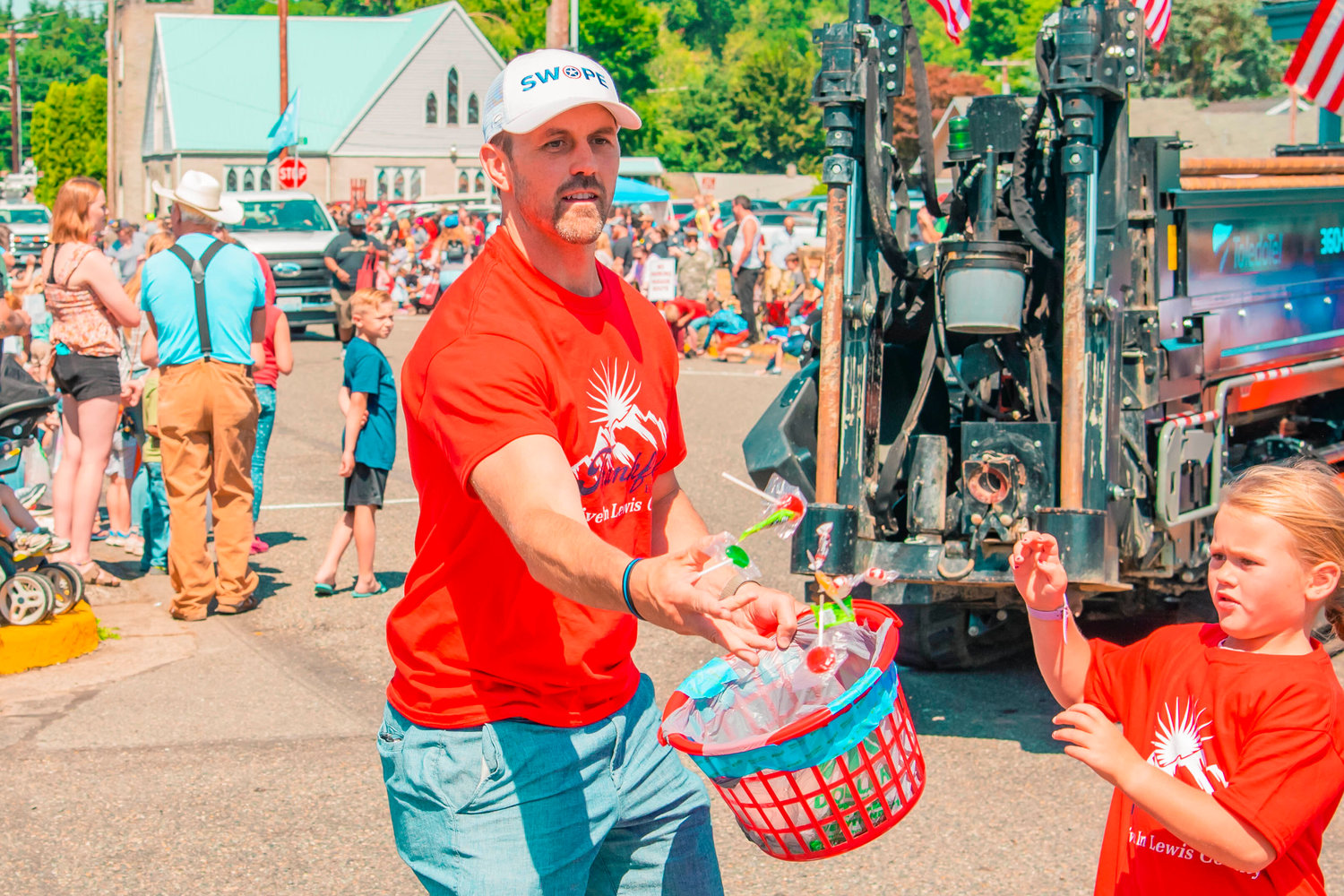 Sean Swope throws candy Saturday during the Toledo Cheese Days parade.