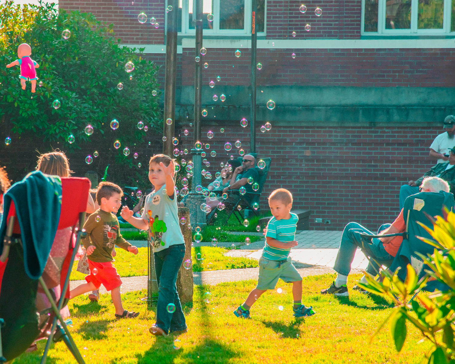 Kids play in bubbles in George Washington Park Saturday in Centralia as music plays from the park gazebo.
