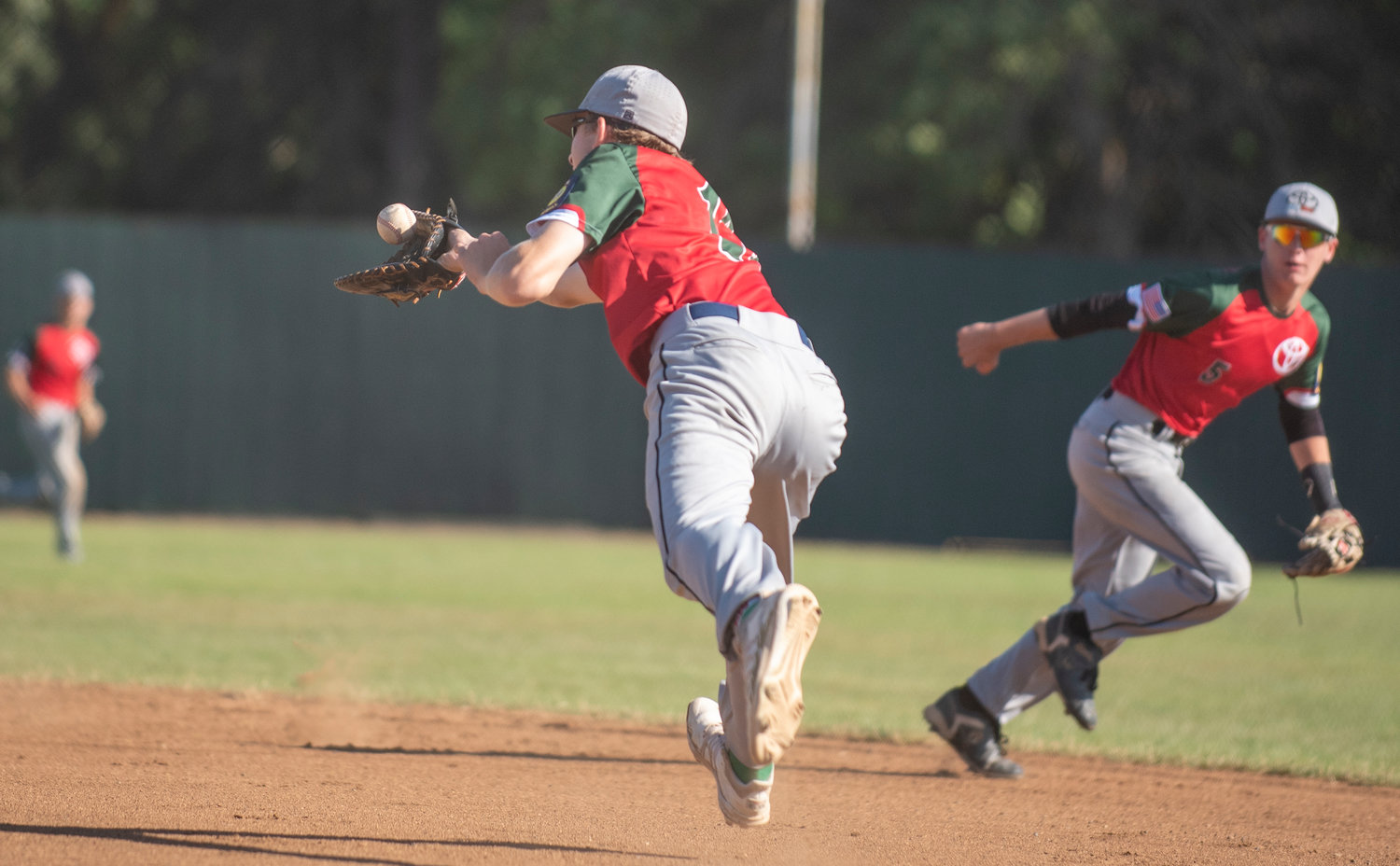 I-5 Toyota/Mountain Dew’s Lethon Fitch, left, snags a grounder near first base while second baseman Brady Sprague (5) watches in the background.