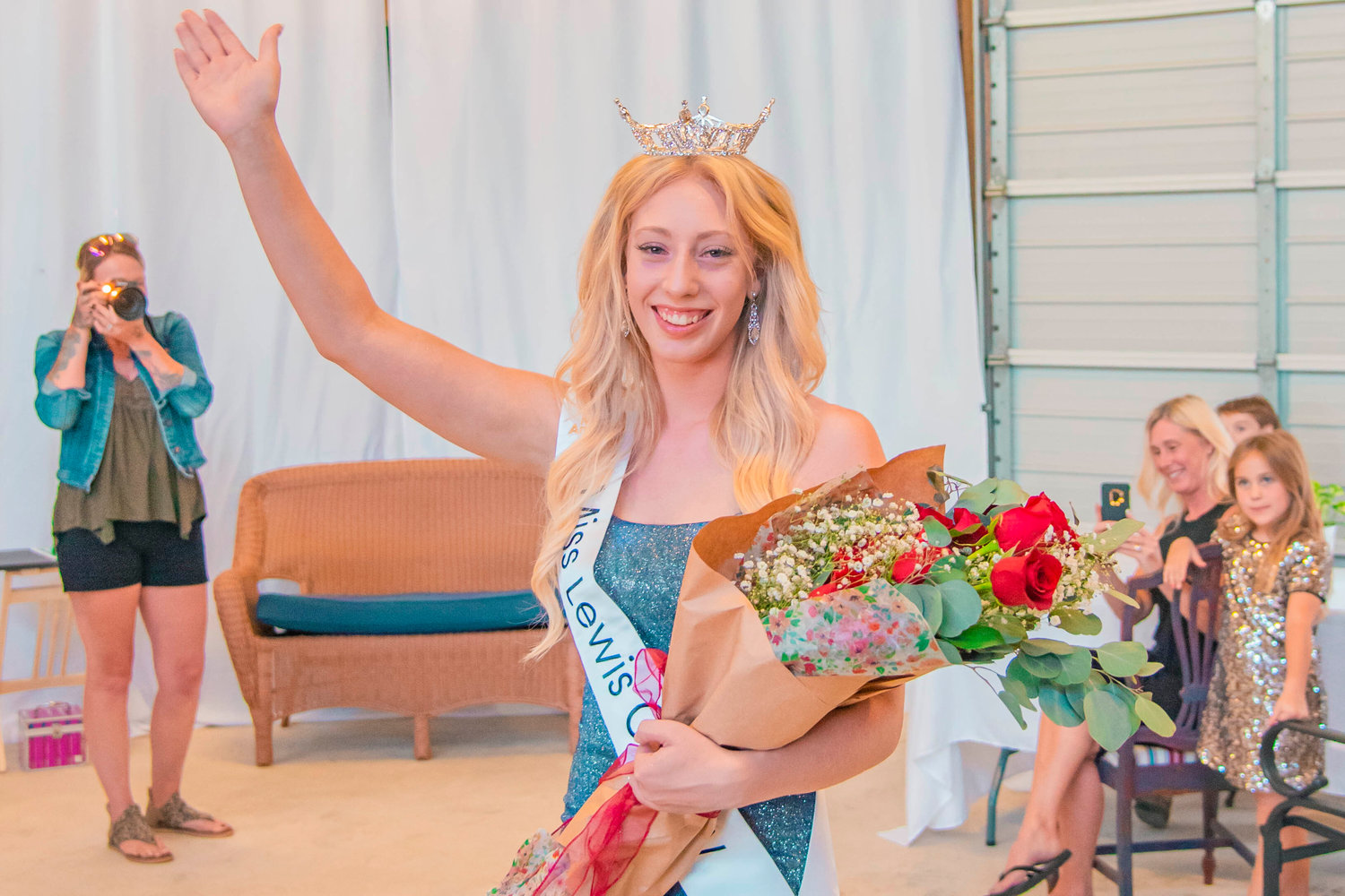 Sophie Moerke smiles and waves after being crowned Miss Lewis County during a ceremony in Chehalis on Monday.
