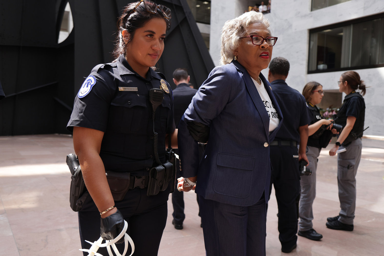 U.S. Rep. Joyce Beatty (D-Ohio), second from left, Chair of the Congressional Black Caucus (CBC), is led away by a member of the U.S. Capitol Police during a protest at the Hart Senate Office Building Thursday, July 15, 2021, on Capitol Hill in Washington, D.C.