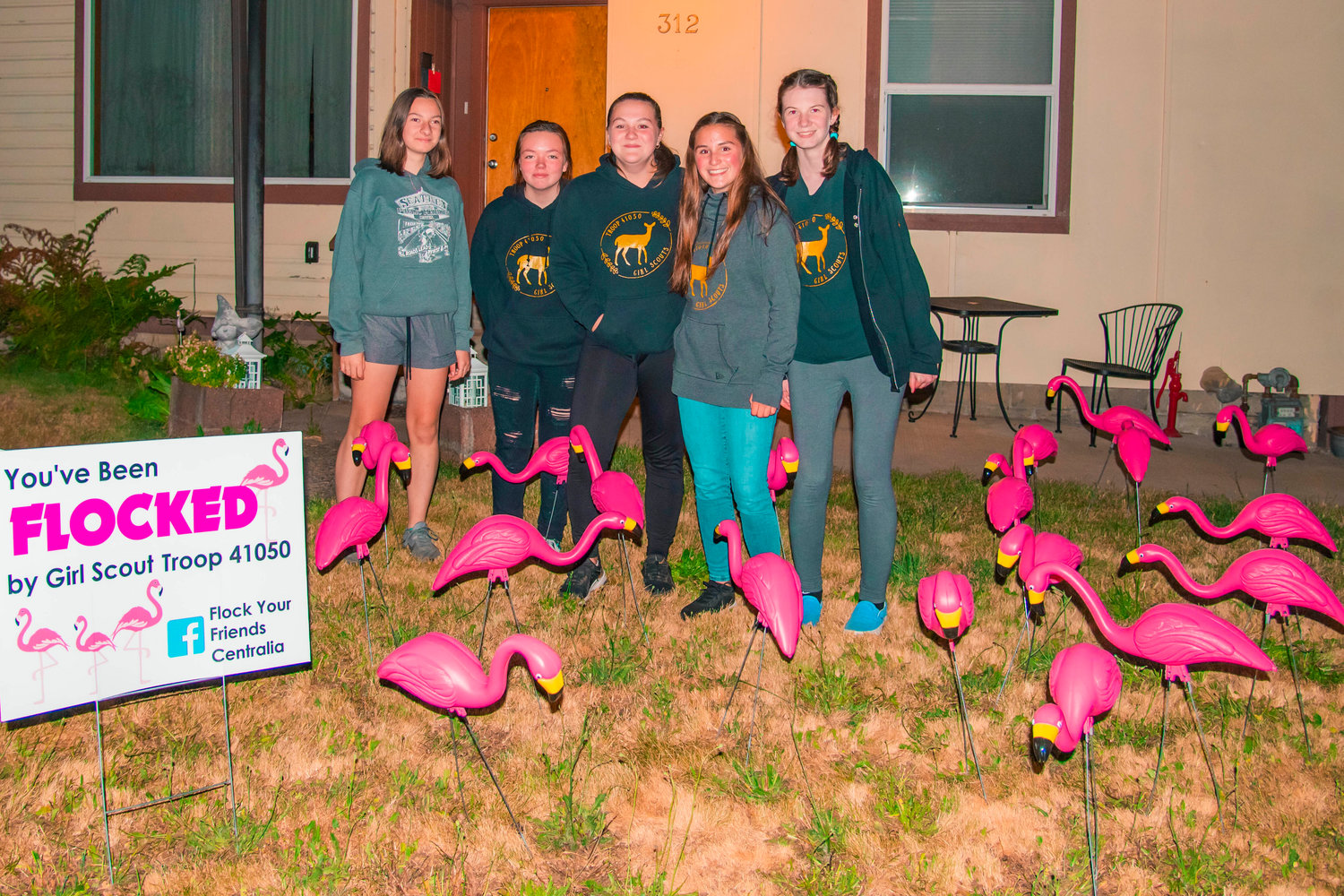 Payton Hile, Kimberlie Bruner, Natalia Hedgers, Olivia Hedgers and Susannah Berry with Troop 41050 pose for a photo next to flamingos after a flocking in Centralia on Wednesday. Not pictured is troop member Layla VonWald.