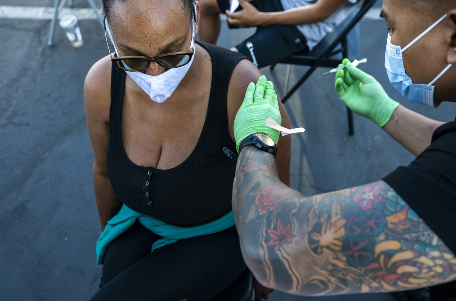 Tamara Pitman, 44, left, of Long Beach is vaccinated by Marc Ocampo, right, on Tuesday, July 6, 2021 in Long Beach, California.