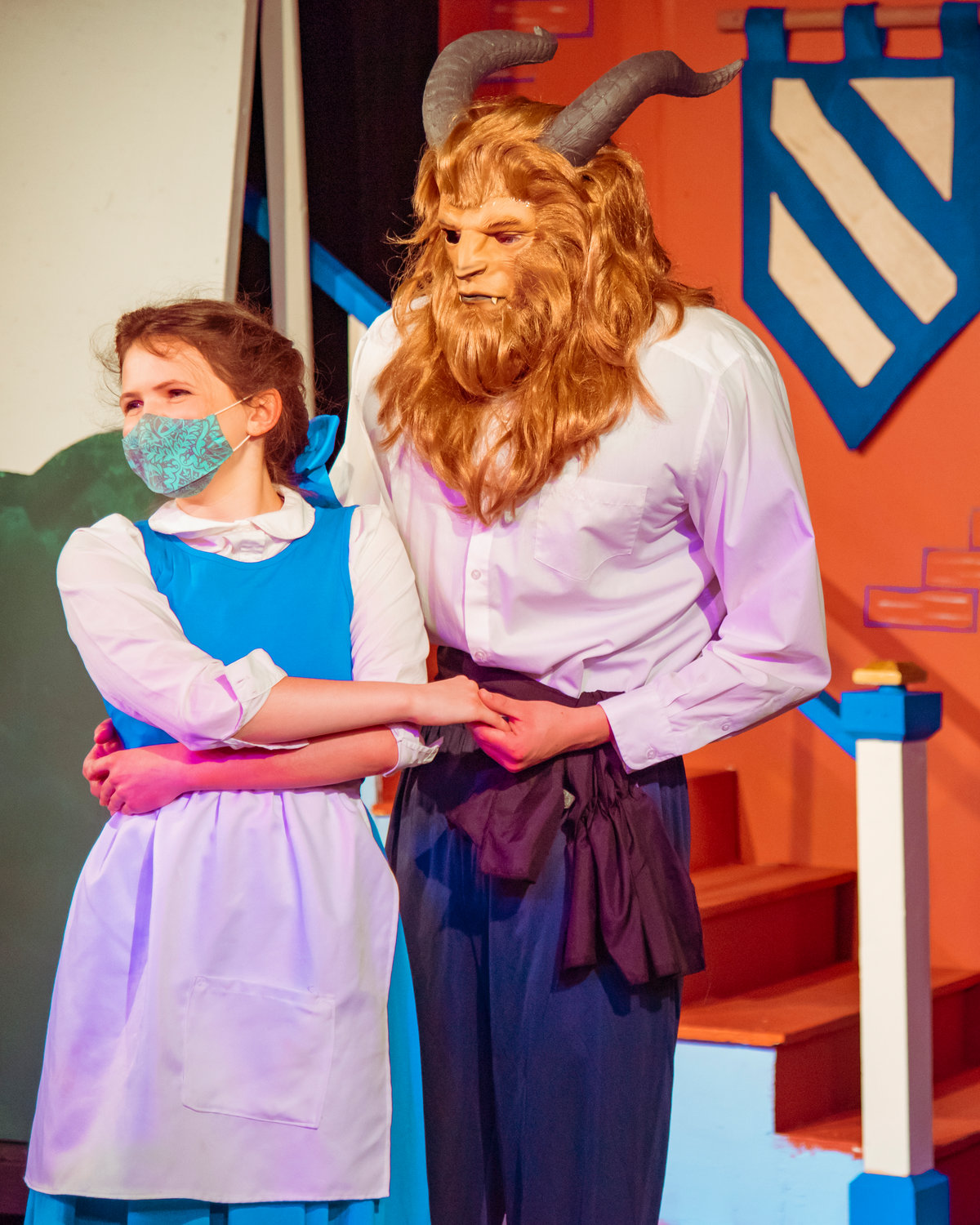 Lenora Page playing Belle and Nathan Crummett portraying the Beast sport masks during dress rehearsals for the Beauty and the Beast Musical Tuesday at the Evergreen Playhouse in Centralia.