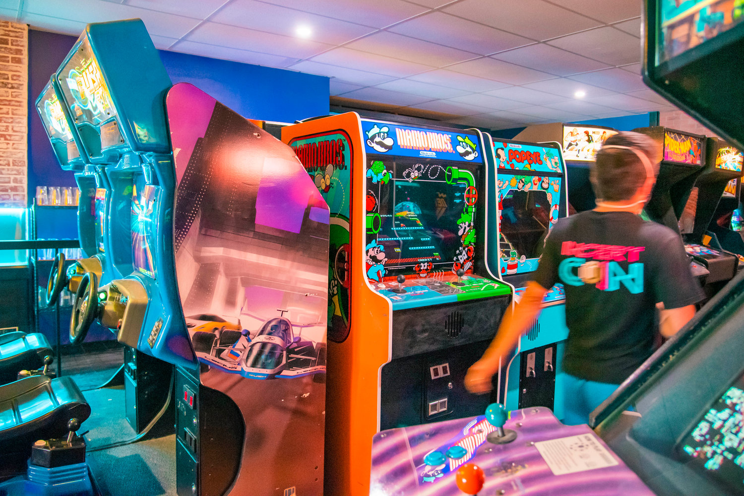 Retro arcade machines illuminate the inside of Insert Coin earlier this month.