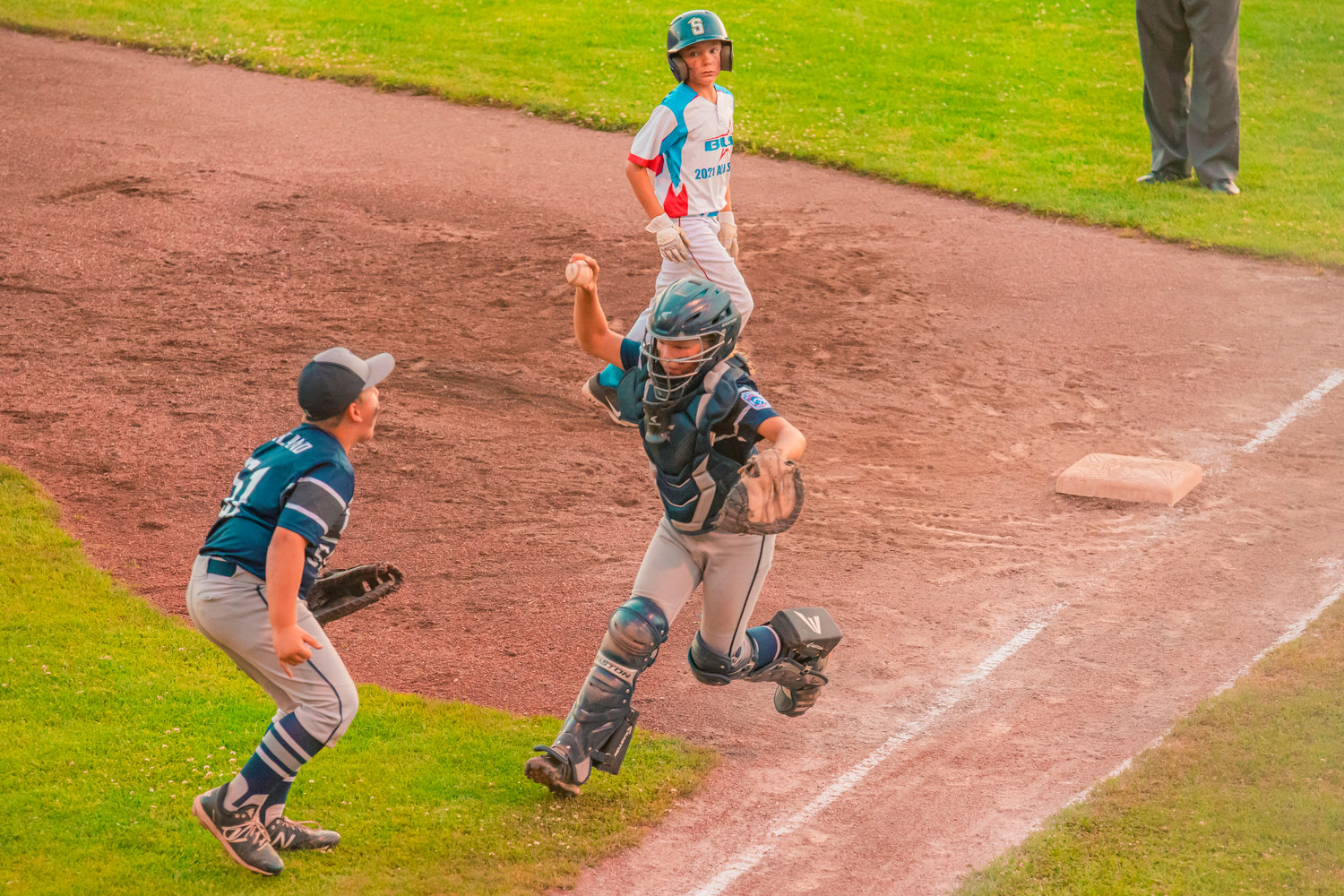 Larch Mountain first baseman Kohlton Wayland (51) celebrates after catcher Marshall Turnquist pulls off an unassisted double play.