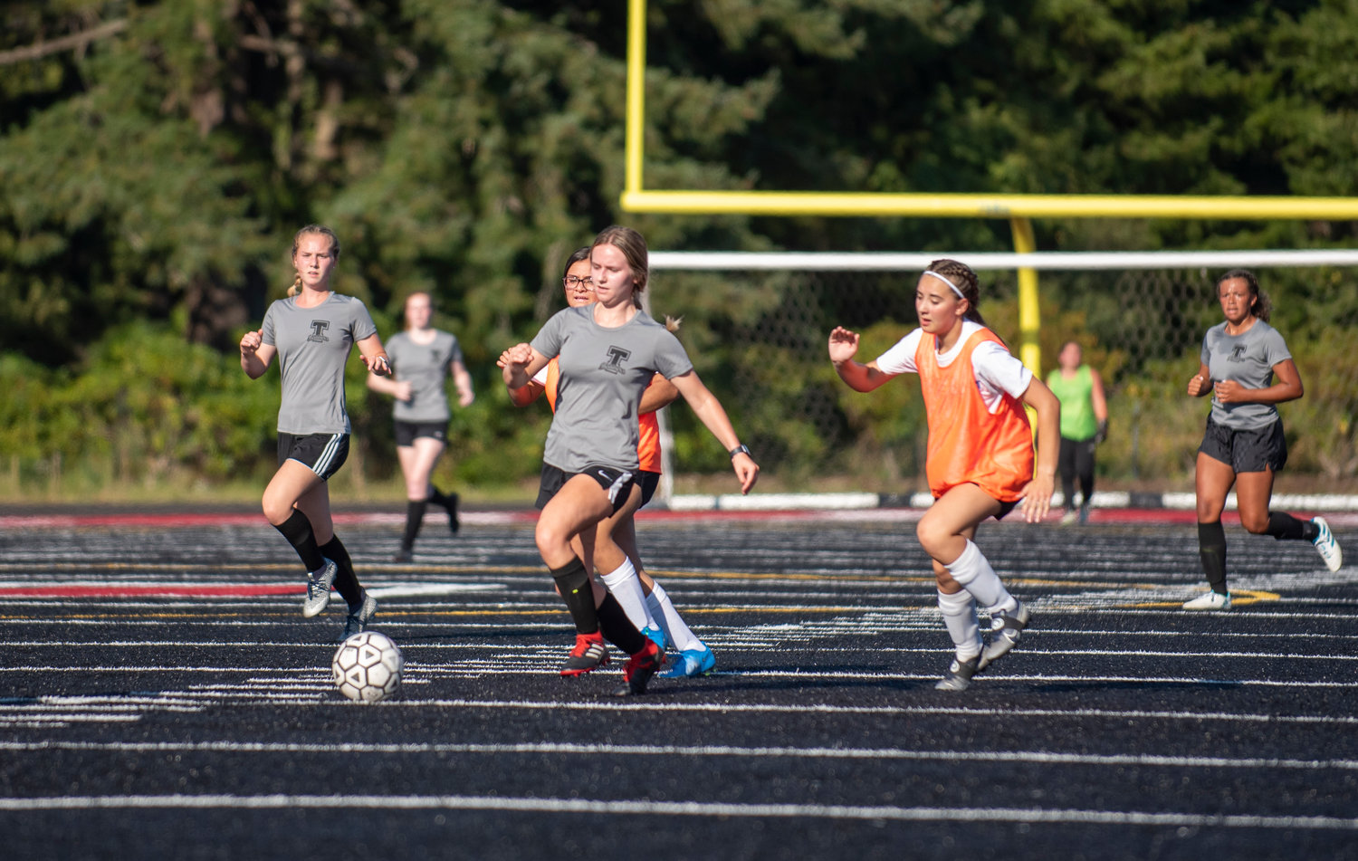 Tenino's Grace Vestal, middle, takes off with the ball downfield against Rochester on Thursday.