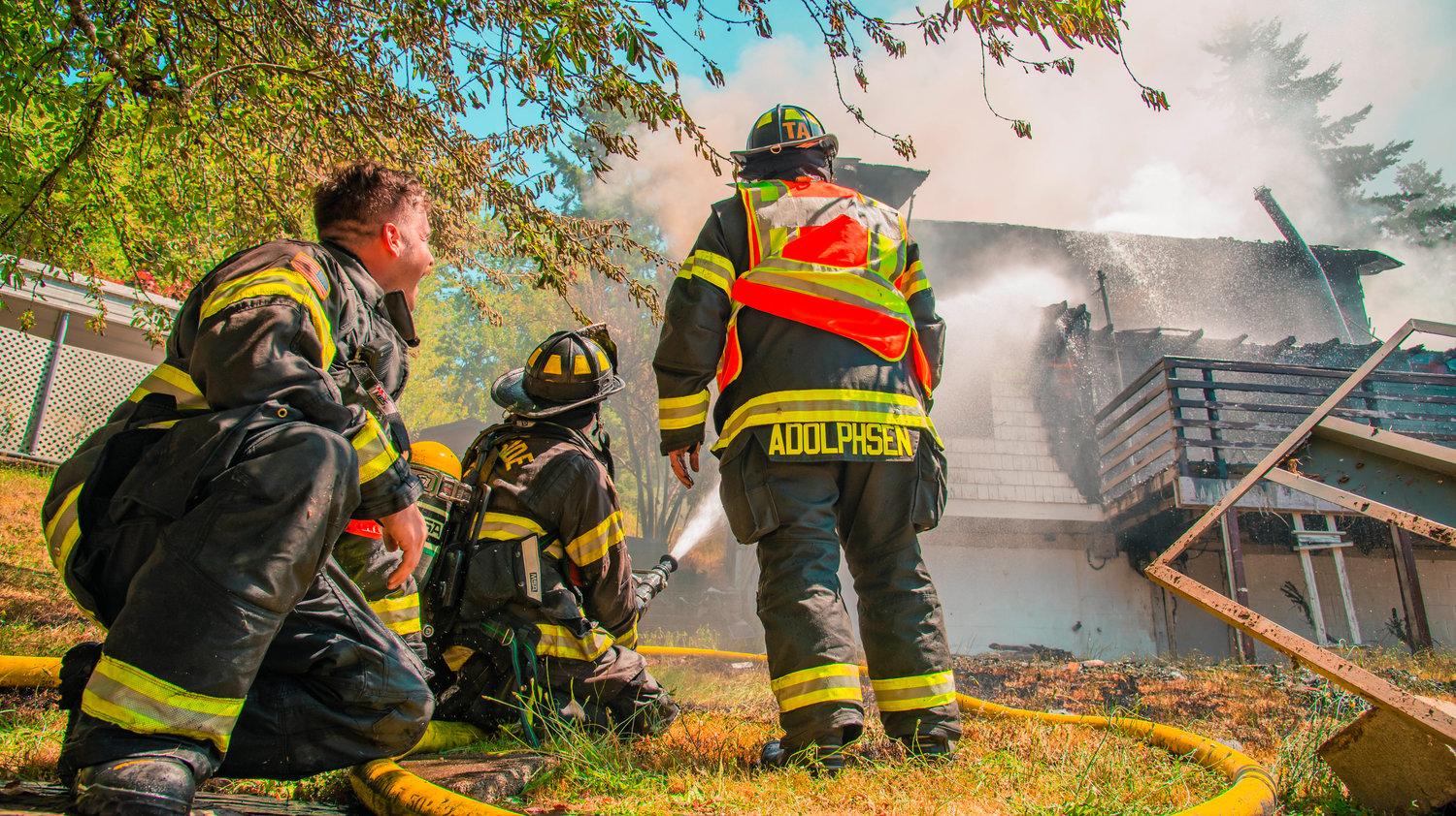 Riverside Fire Authority firefighters use a hose to put out flames at a residential structure on East Third Street in Centralia on Thursday.