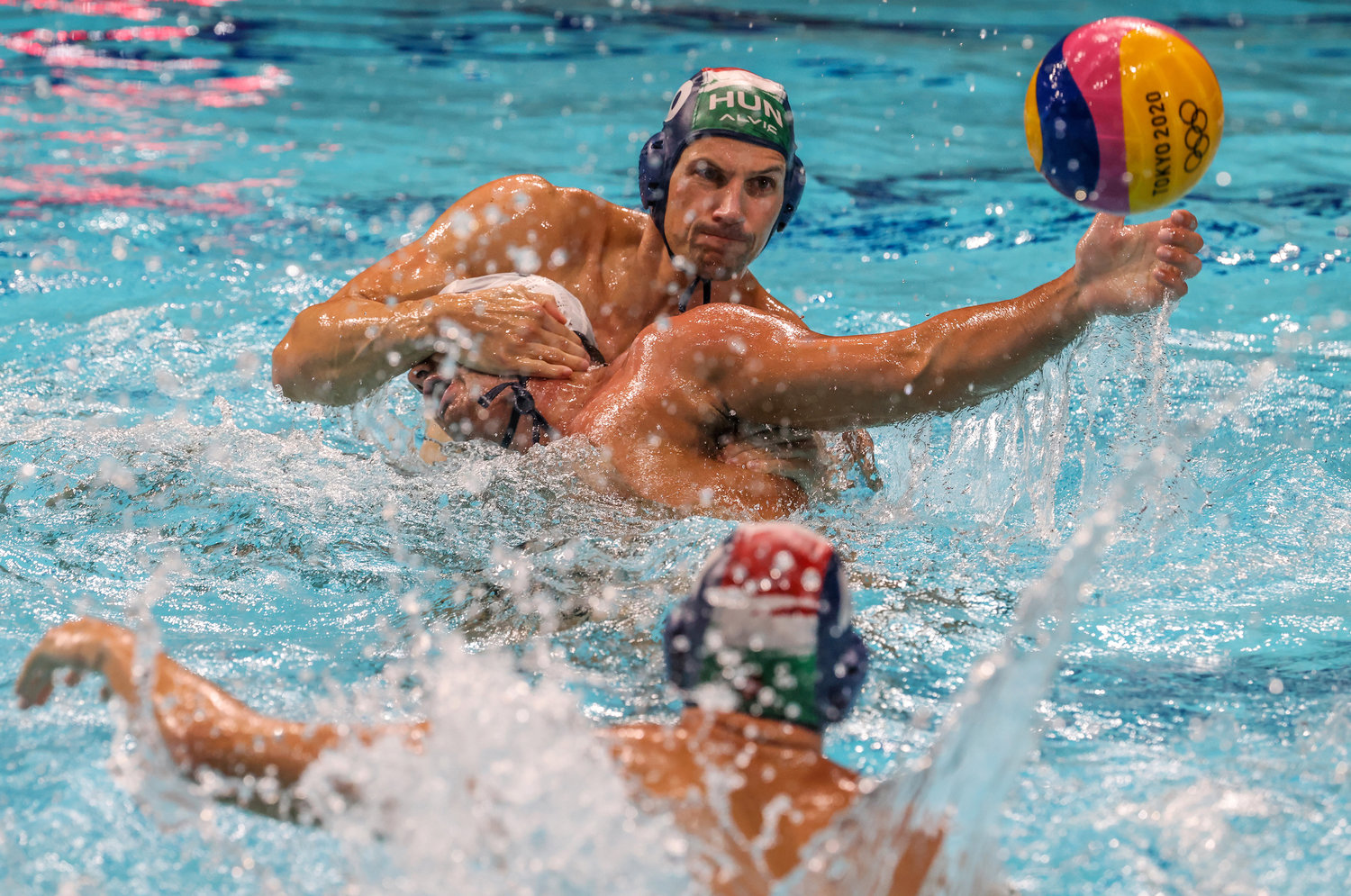 Team United States forward Ben Hallock (7) is smothered by Team Hungary driver Denes Varga (10) in a Water Polo Men's Prelim at Tatsumi Water Polo Center on Saturday, July 31, 2021 in Tokyo, Japan.