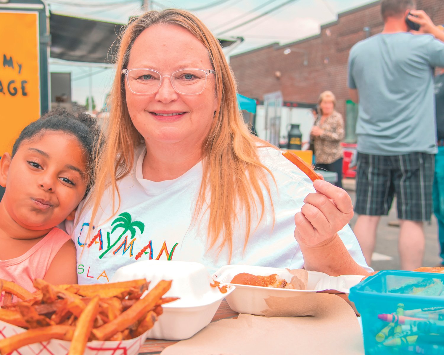 Laverda Hartley, right, smiles and poses for a photo with Chloe Blount while enjoying food during ChehalisFest on Saturday.