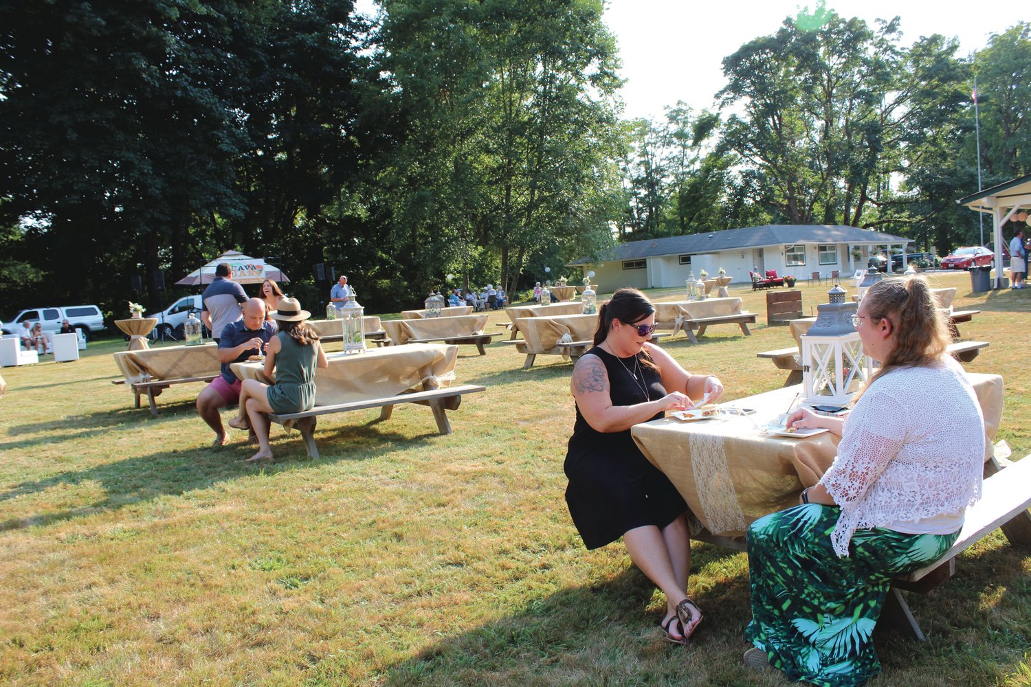Timi Johnson and Rebecca Towner, of Twin Transit, enjoy some food at one of several picnic tables at the Chehalis Foundation's Party in the Park fundraiser. Planning committee members planned the event with COVID safety in mind, opting for an outdoor event with socially distanced seating.