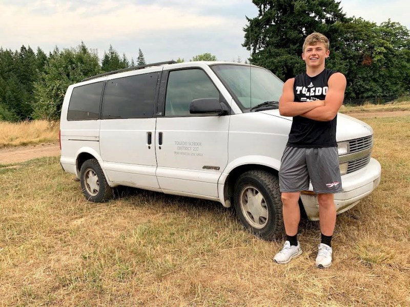 Toledo senior Wyatt Nef with the 2000 Chevrolet Astro van he purchased to haul his football teammates to workout sessions.