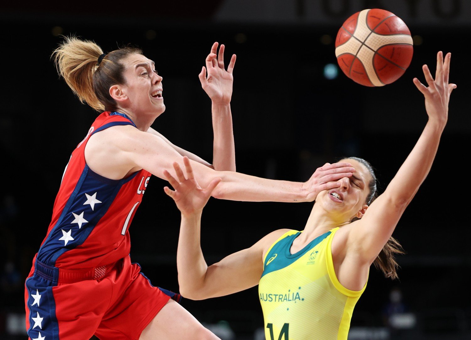 Australia's center Marianna Tolo is hit in the face by the United States forward Breanna Stewart as they chase a loose ball from in the first half of the Women's Basketball Quarterfinal at Saitama Super Arena on Wednesday, Aug. 4, 2021.