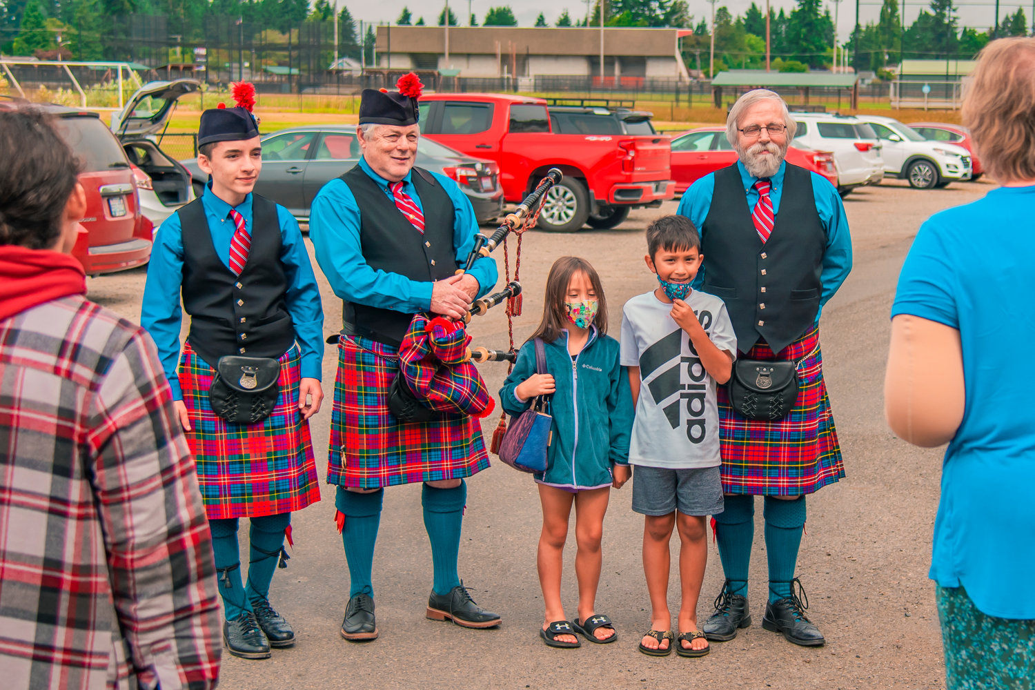 Bagpipers mingle with attendees following a performance outside the Borst Park Pioneer Church in Centralia Saturday morning.