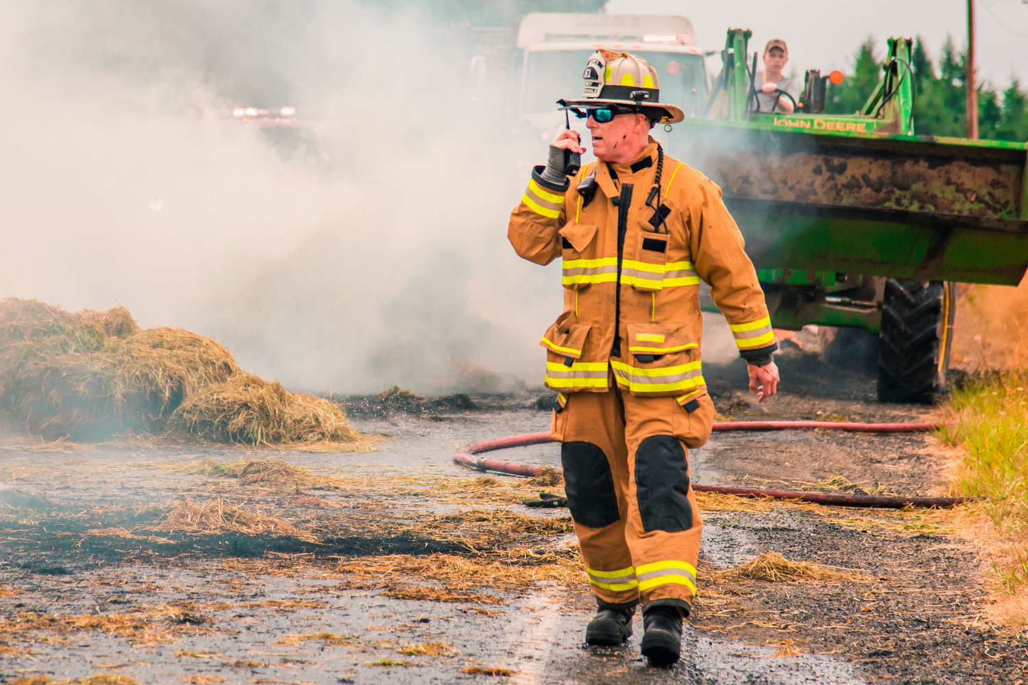 Lewis County Fire District 6 Chief Ken Cardinale responds to a hay truck fire on Highway 603 at the intersection of Tune Road west of Chehalis on Saturday.